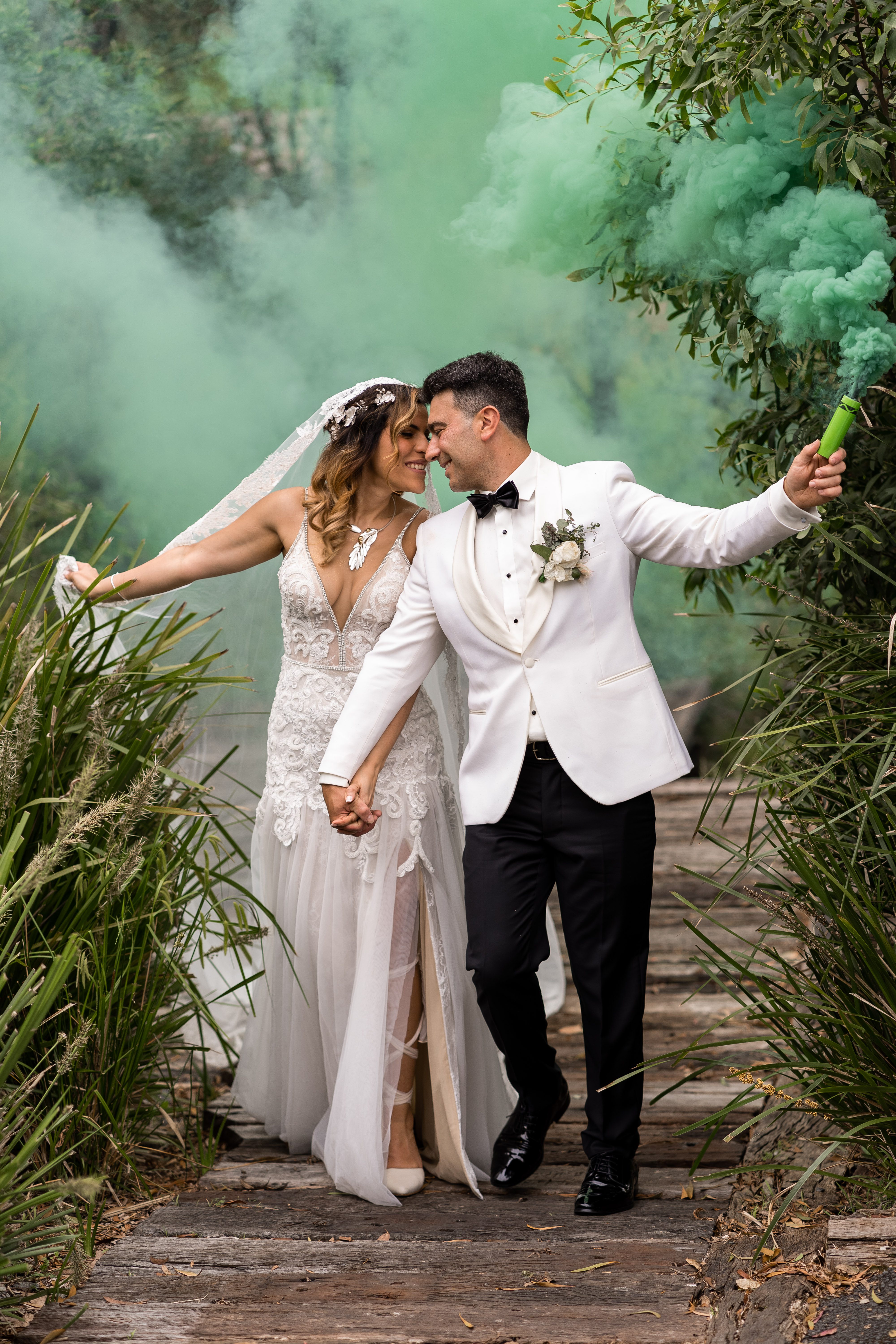 Bride and groom in a coastal landscape with tall grasses