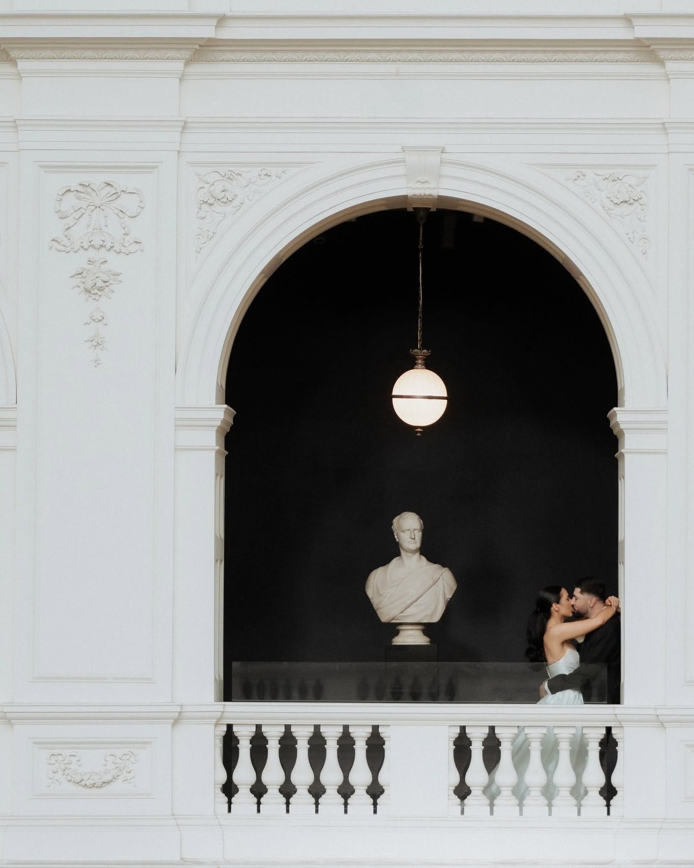 Couple by an arched doorway in a classical Melbourne interior