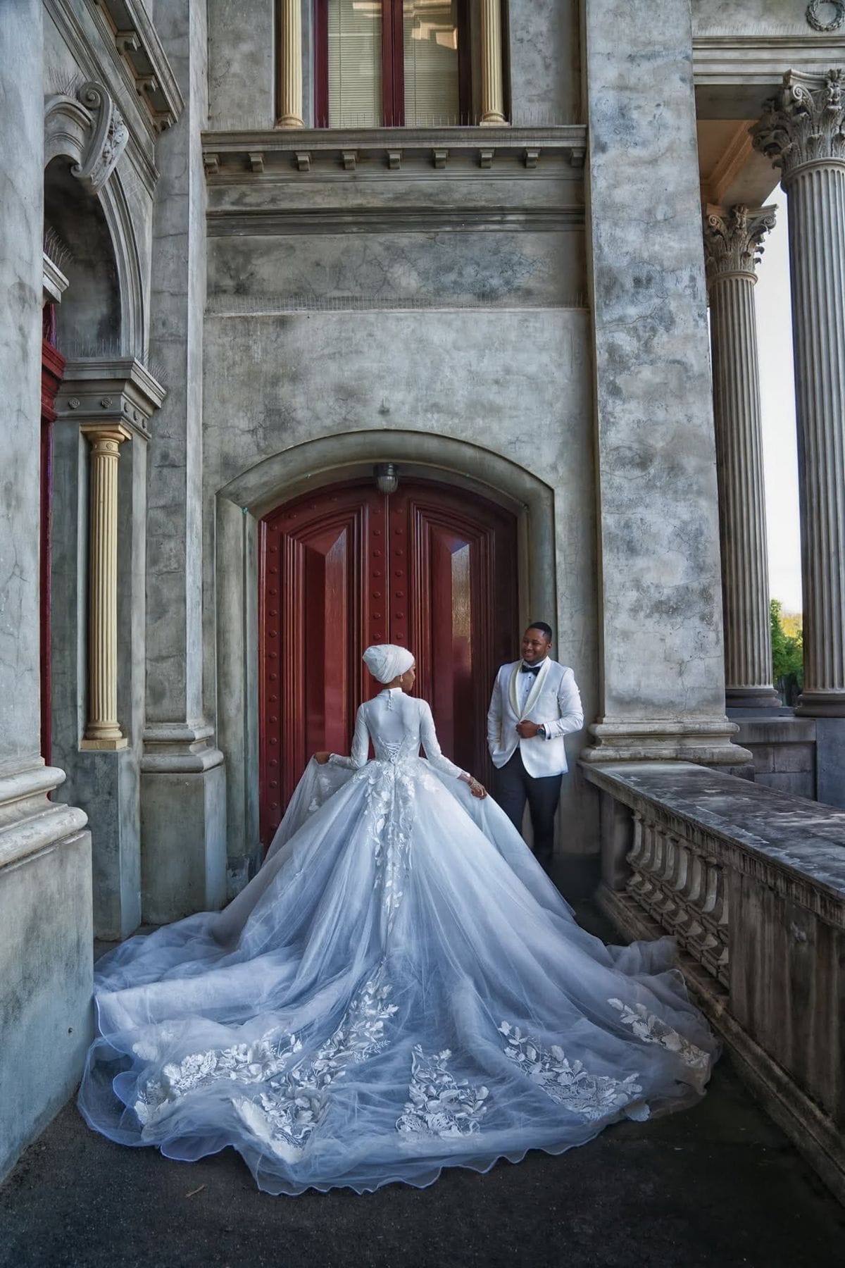 Bride and groom by a heritage red door, blue ballgown — Melbourne wedding