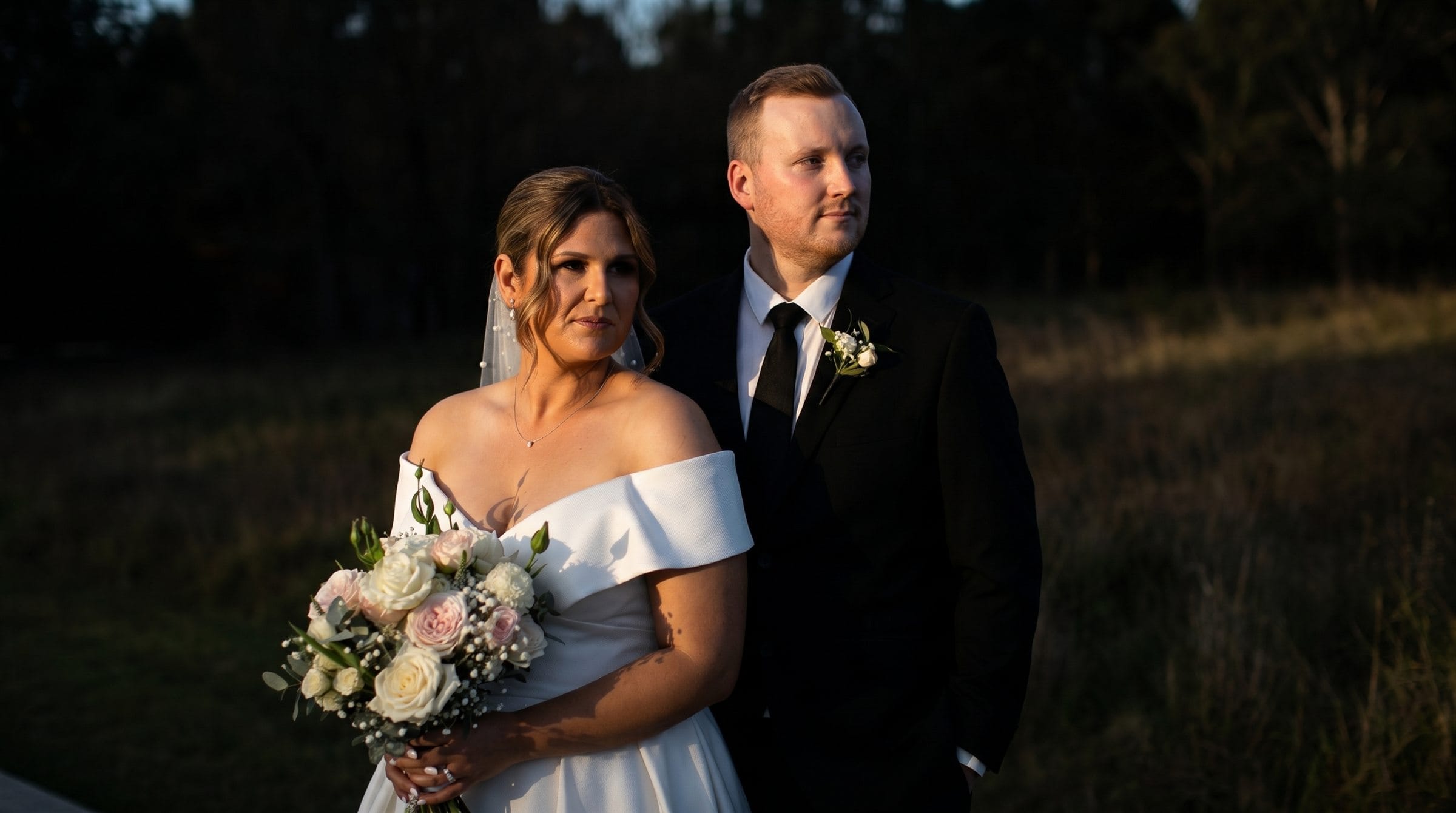 Newlyweds holding a bouquet at Fergusson Winery