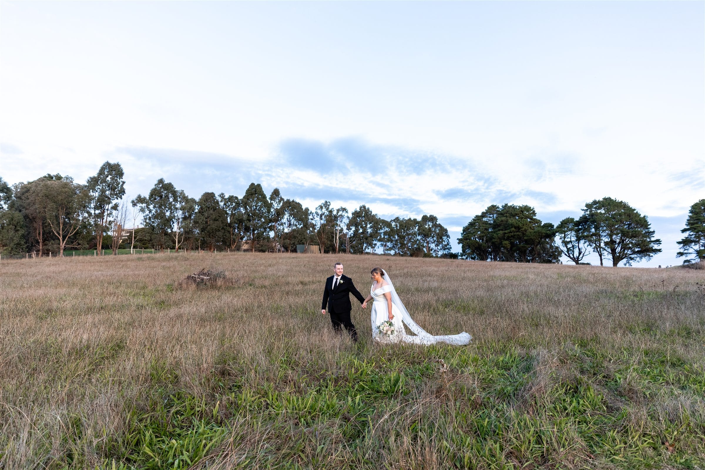Newlyweds walking together at Fergusson Winery