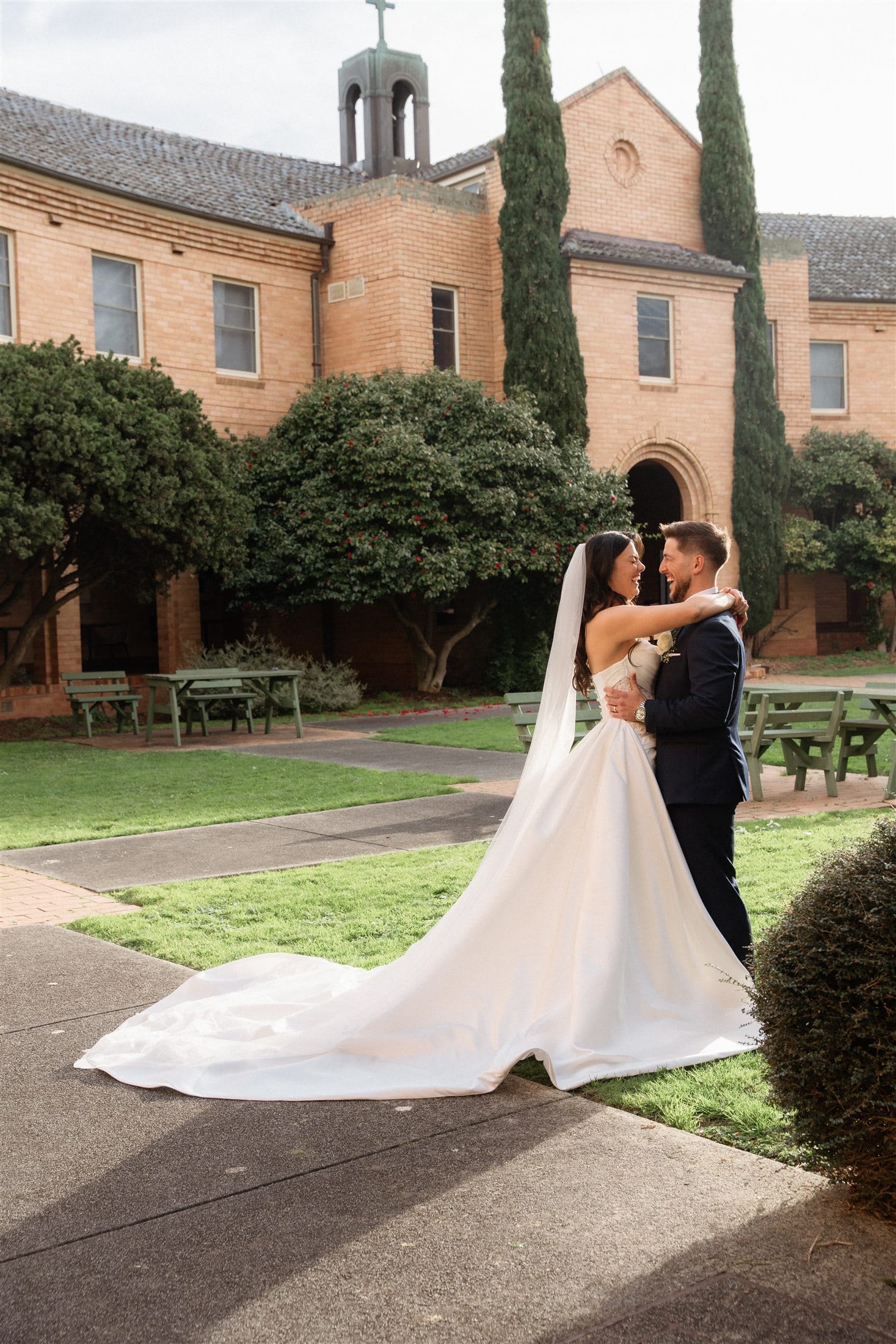 Afonso and Agnes together in front of a brick church building