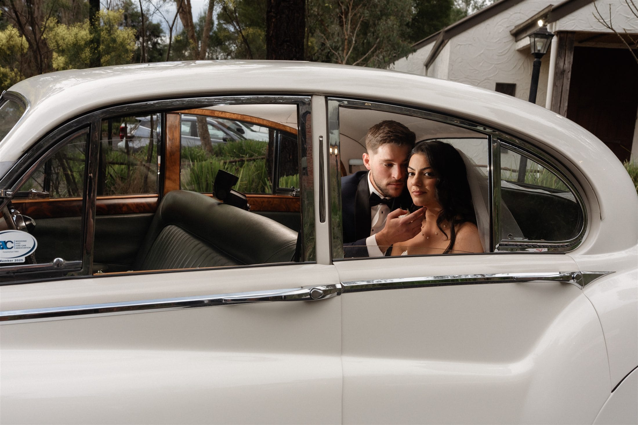 Afonso and Agnes together inside the white vintage car