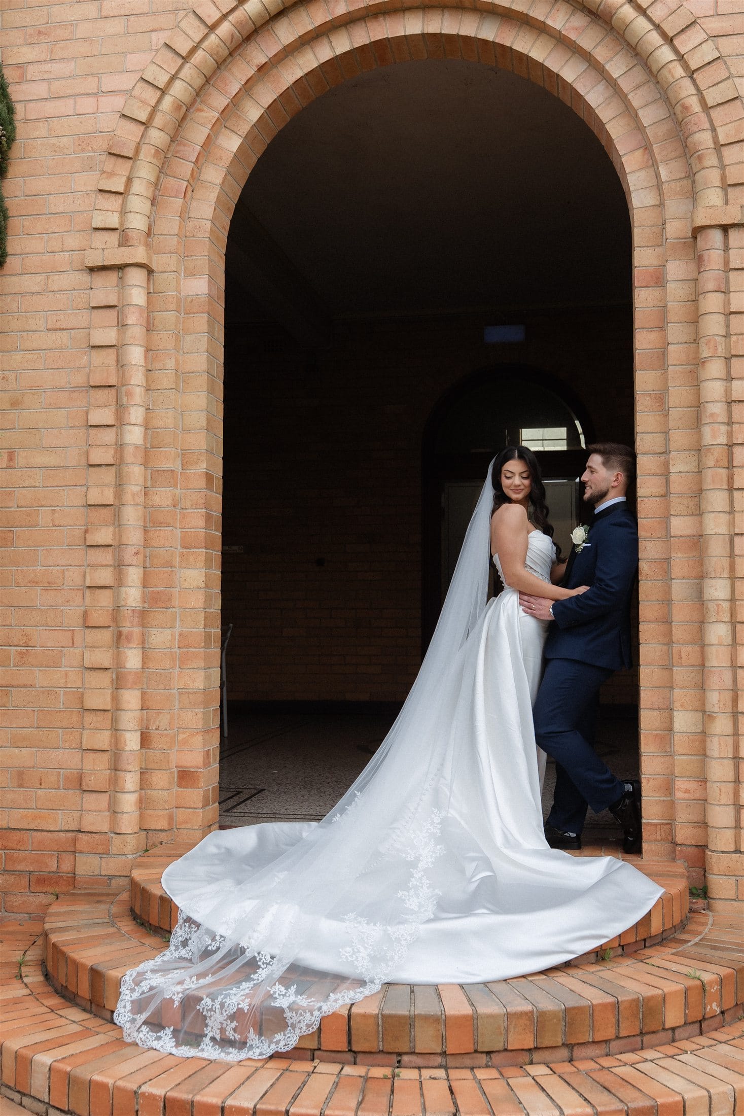Afonso and Agnes together beneath a brick arch