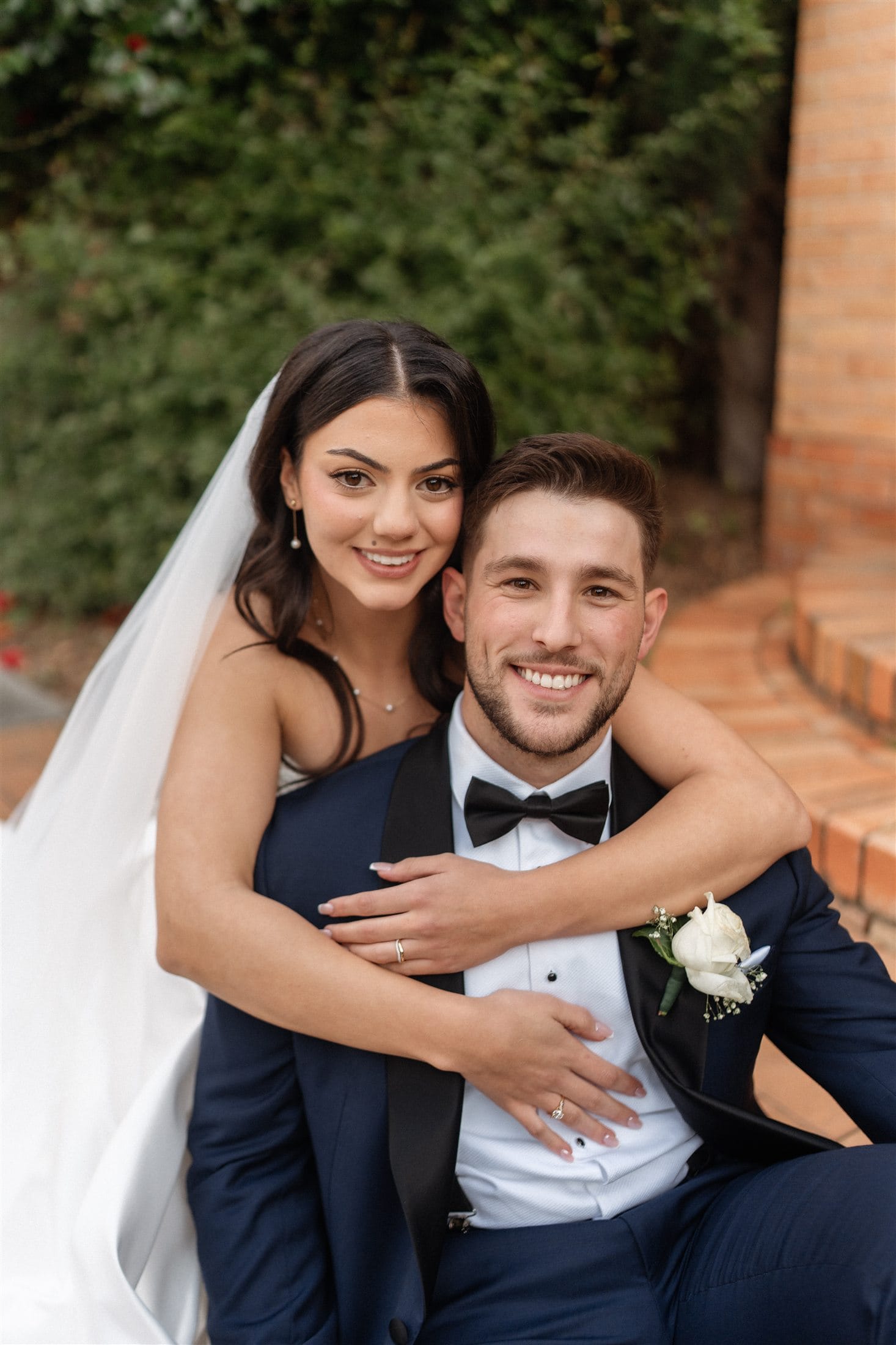 Afonso and Agnes smiling in a close wedding portrait